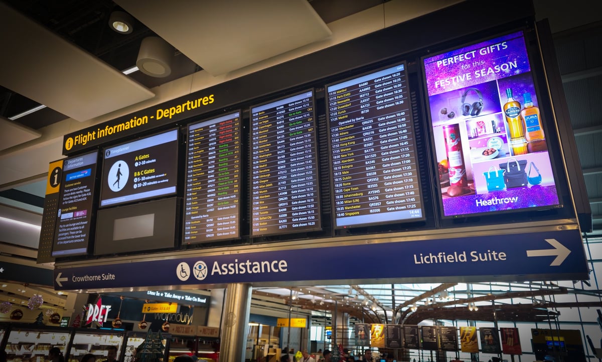 Airport departure information screens inside a modern terminal